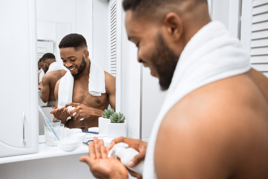 smiling man squeezing foam into hands